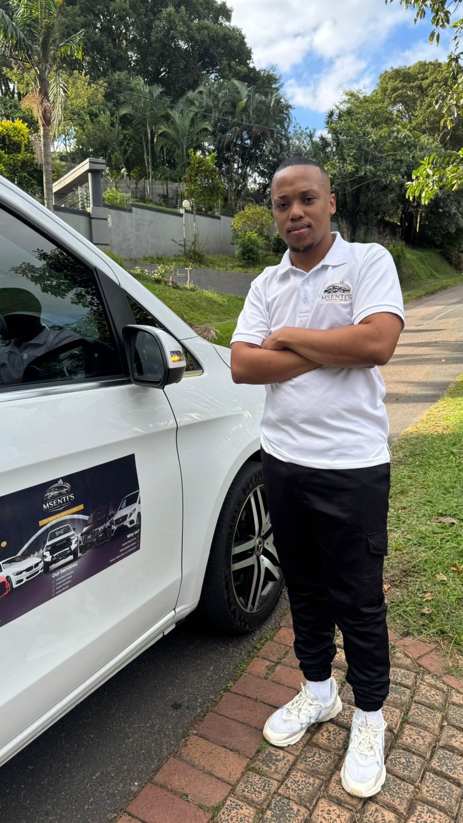 Owner Philani Blose standing next to a Msenti's Luxury Transport vehicle